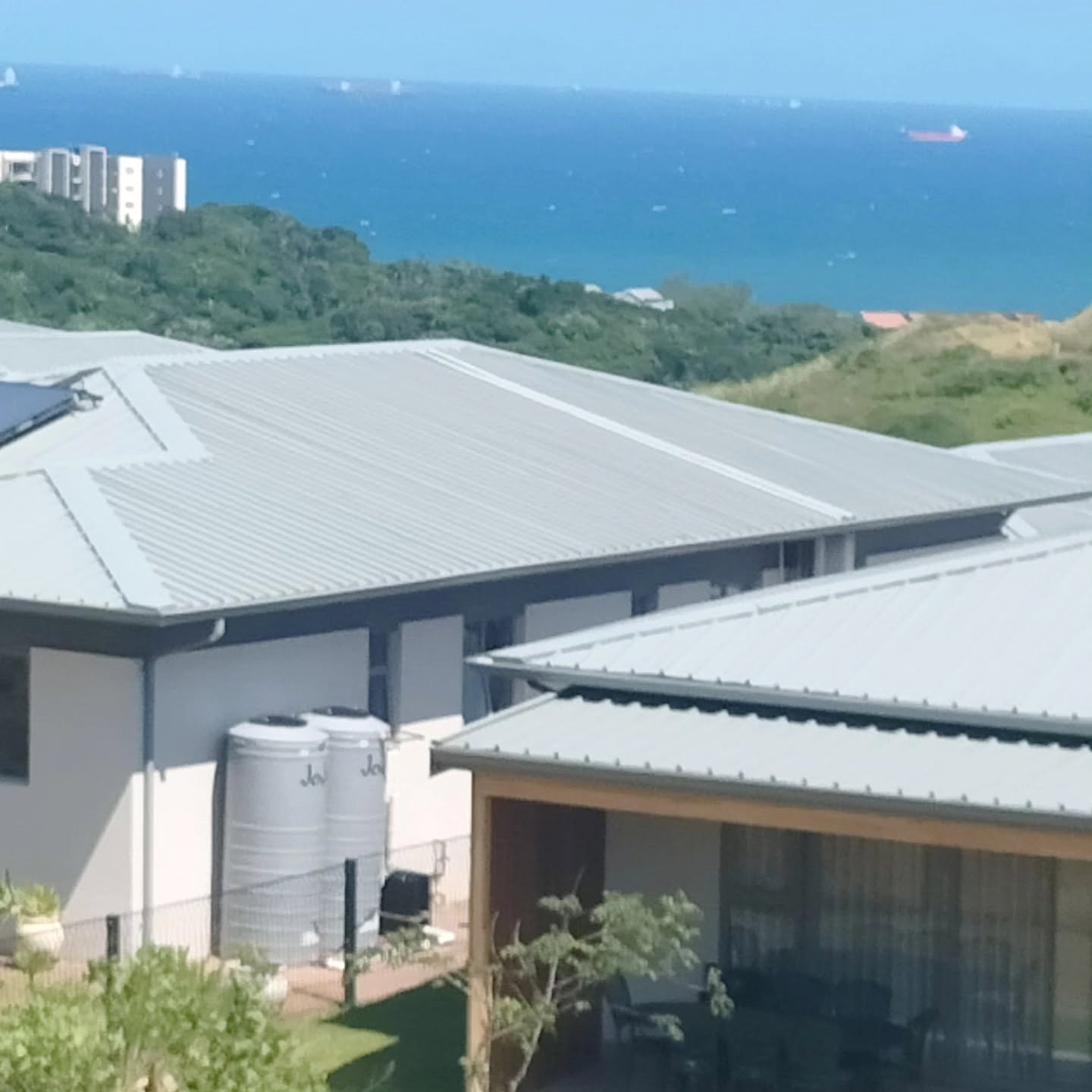 Frameless glass balustrade on a rooftop pool deck overlooking the ocean, KwaZulu-Natal